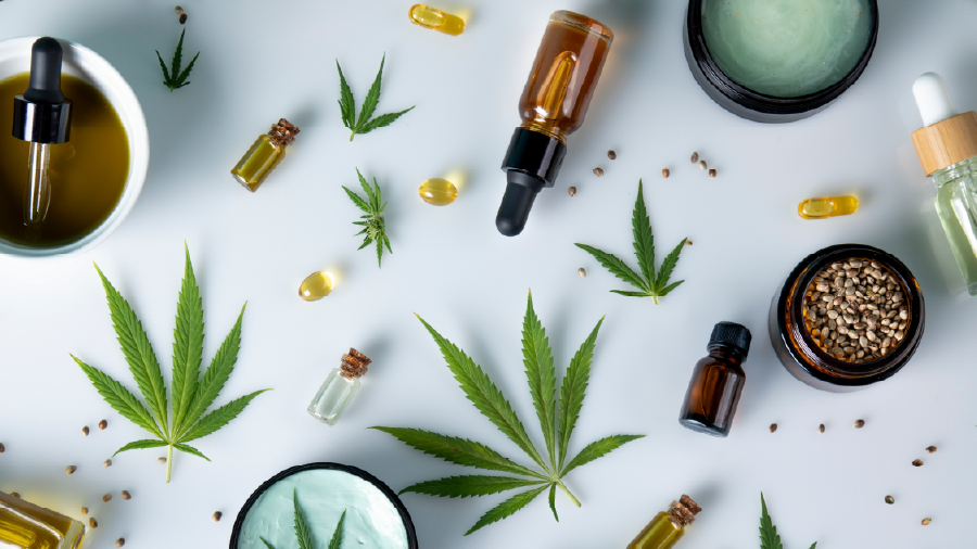 various hemp products including leaves, seeds, tinctures, capsules, etc. on a white background
